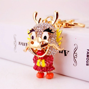 Sparkling Chinese Dragon Keychain with red rhinestones and gold plating on white background