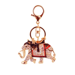 Sparkling crystal elephant keychain with gold alloy finish and colorful enamel saddle detail