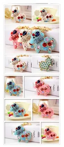 Detail view of rhinestone sheep keychains in various colors with golden metal rings