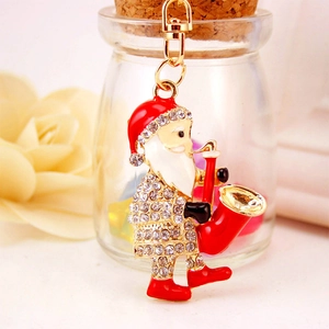 Porte-clés Père Noël jouant du saxophone avec émail rouge et strass blancs brillants