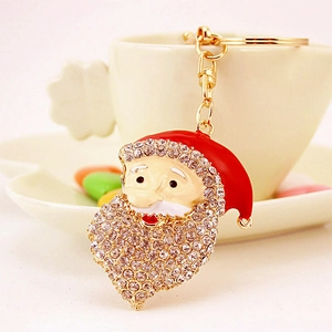 Portachiavi Babbo Natale scintillante con strass e gancio dorato su tazzina di caffè