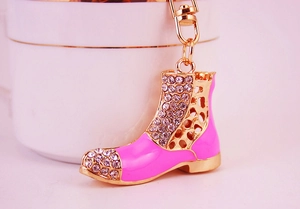 Detailed view of pink rhinestone-studded boot keychain with gold metal hardware