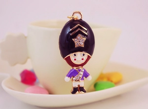 Close-up of royal guard keychain with purple enamel finish and sparkling rhinestone star