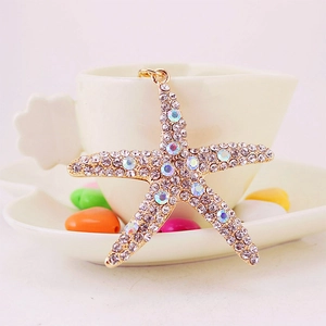 Sparkling crystal rhinestone starfish keychain pendant in gold metal with rainbow accents