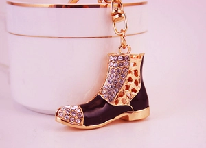 Detailed macro view of boot keychain featuring sparkling rhinestones and black enamel finish
