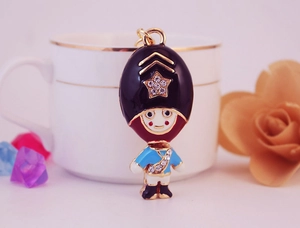 Macro view of a cartoon British royal guard keychain with enamel finish and rhinestone star