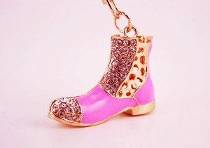 Detail of pink enamel boot keychain with sparkling white rhinestones and gold ring