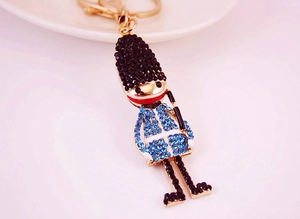 Close-up of royal guard keychain with blue and black rhinestones on gold alloy base