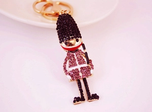 Close-up of a royal guard keychain with sparkling rhinestones and golden metal frame