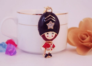Macro detail of royal guard keychain showing rhinestone stars and red enamel finish