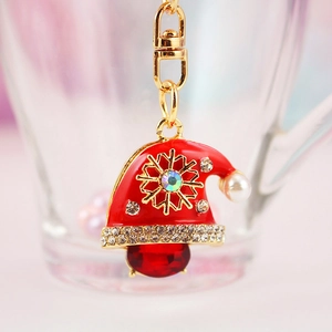 Porte-clés bonnet de Noël strass avec perle rouge et flocon de neige doré scintillant