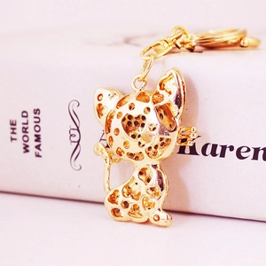 Golden cat keychain with geometric hollow-out patterns on a simple white background