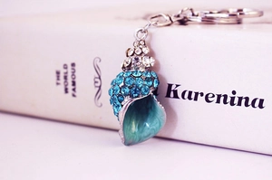 Detailed view of sea snail keychain with blue rhinestones and gradient enamel finish