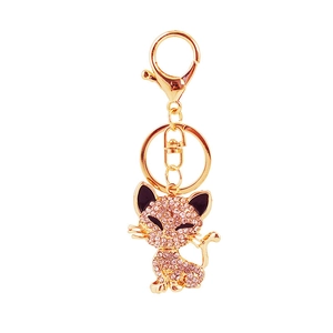 Charming golden cat keychain featuring pink rhinestones and a lobster clasp for bag decor