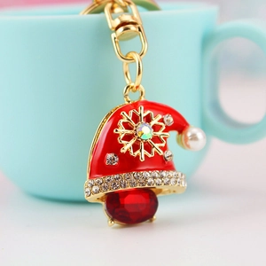 Porte-clés bonnet de Noël étincelant avec pierre rouge et motif flocon de neige doré
