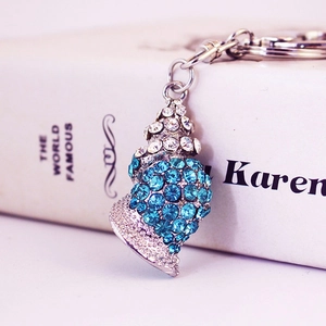 Creative conch keychain with blue and clear crystals on a silver metal base