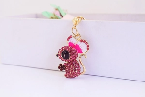 Detailed close-up of a pink crystal-encrusted mouse keychain with golden lobster clasp