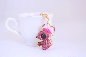Macro detail of cute mouse keychain featuring pink crystal rhinestones and enamel ears