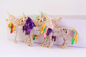 Detailed view of three colorful rhinestone unicorn keychains with gold metal plating