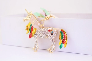 Detail of colorful enamel unicorn keychain with sparkling crystal rhinestones and gold ring