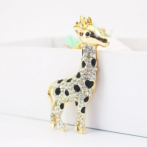 Sparkling gold giraffe keychain with white crystals and black enamel on gift box