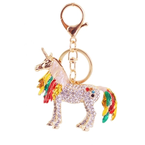 Colorful unicorn keychain with sparkling crystals and golden metal finish on white background