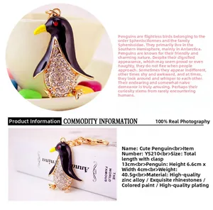 Detail showing the 6.6cm height of the sparkling penguin keychain with gold zinc alloy