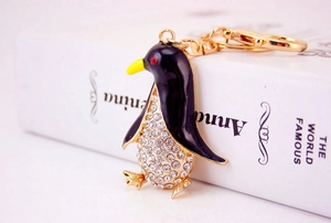 Detail of penguin keychain with gold base, black enamel, and white rhinestones