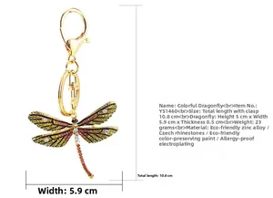 Detailed view of golden dragonfly keychain with dimensions and colorful rhinestones