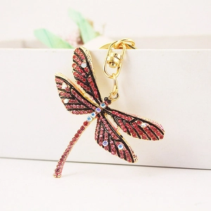 Charming dragonfly keychain with pink rhinestones on a gold metal frame for bags