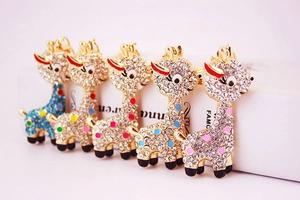 Close-up of five rhinestone giraffe keychains in colorful gold-plated metal finish