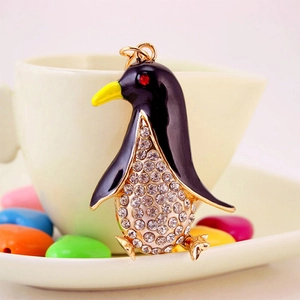 Cute penguin metal keychain with black enamel and sparkling white rhinestones on golden frame