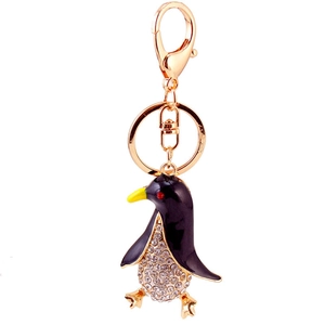 Cute golden penguin keychain with sparkling crystals and black enamel finish for women
