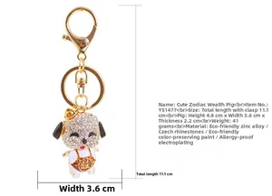Detail of cute pig keychain with sparkling white rhinestones and traditional red vest