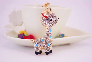 Detail of giraffe keychain with sparkling white rhinestones and blue enamel spots