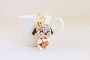 Detail of cute rhinestone dog keychain with red apron and lobster clasp for bag