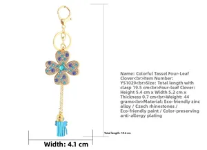 Détails du porte-clés trèfle à quatre feuilles avec strass bleus et pompon en cuir bleu