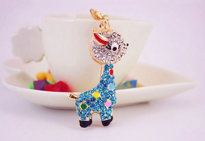 Detail shot of golden giraffe keychain with vibrant blue rhinestones and colorful crystals
