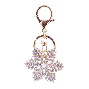 Porte-clés flocon de neige doré avec strass blancs et perle d'imitation centrale