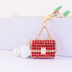 Porte-clés sac à main doré avec strass rouges et breloque fleur de rose blanche