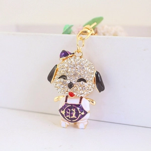 Sparkly rhinestone puppy keychain with golden Wang character and purple bow decoration
