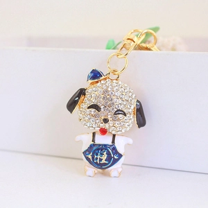 Cute puppy keychain with sparkling rhinestones and blue vest featuring lucky gold character