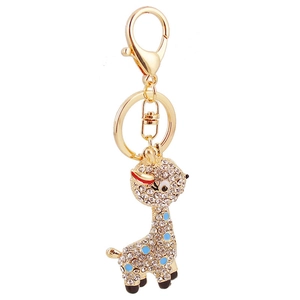 Golden giraffe keychain with sparkling rhinestones and blue enamel on white background
