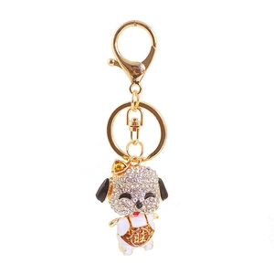 Golden alloy dog keychain with white rhinestones and red traditional lucky outfit