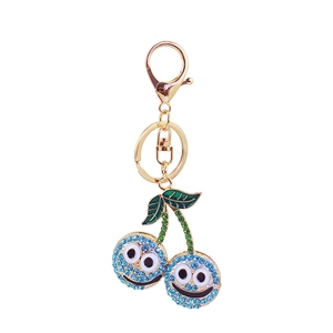 Cute cherry keychain with sparkling rhinestones and smiling face on a gold metal ring
