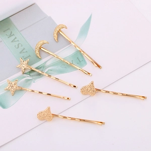 Close-up of six gold-plated hairpins featuring hammered texture star moon heart shapes