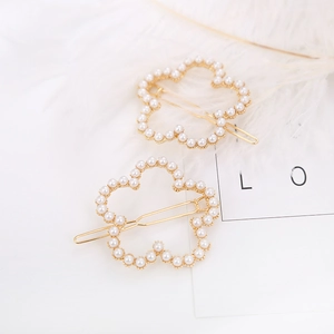 Elegant gold flower hair clips with white pearls set for women with minimalist floral design