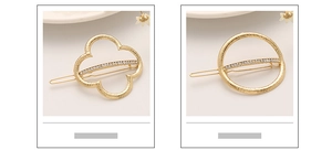 Detail of gold geometric hair clips with hammer finish and sparkling rhinestones