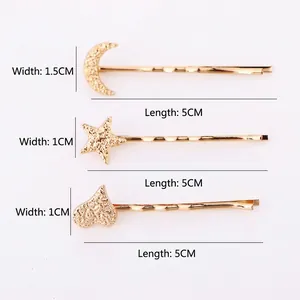 Three-piece gold matte metal hair clips featuring star, moon, and heart shapes