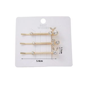 Detailed view of 3-piece gold hair clips with crystal cherry, bow, and rabbit motifs